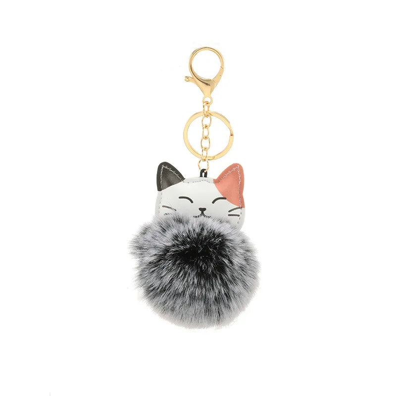 Portachiavi con pompom morbido in pelliccia sintetica e design a forma di gatto, perfetto per accessori e chiavi.