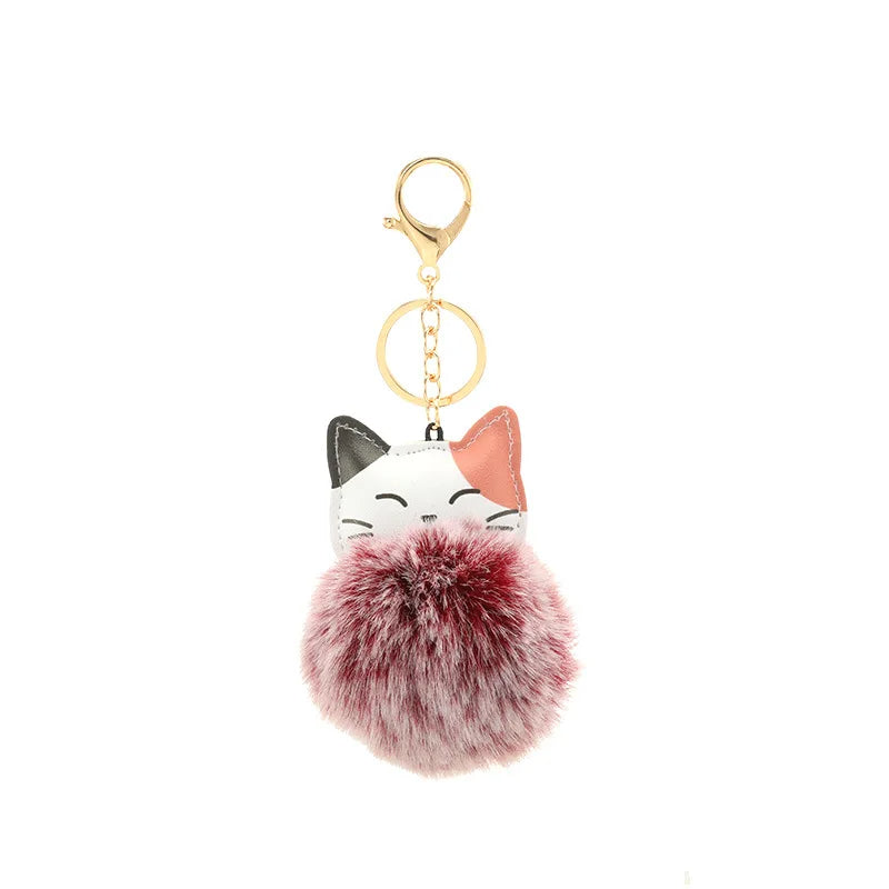 Portachiavi con pompom morbido in pelliccia sintetica e design a forma di gatto, perfetto per accessori e chiavi.